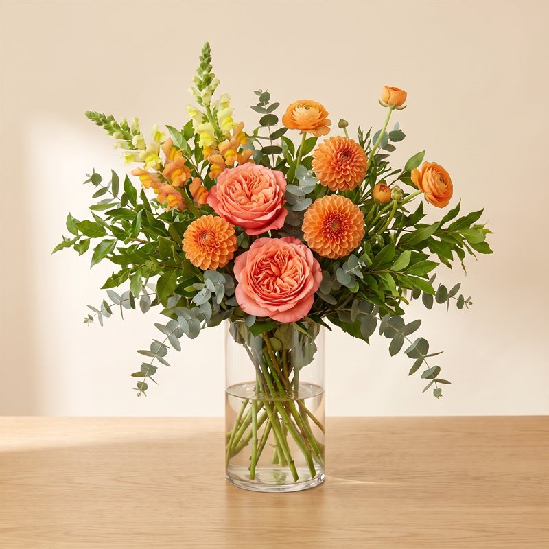 Grand bright designer's choice arrangement in corals and sun colors