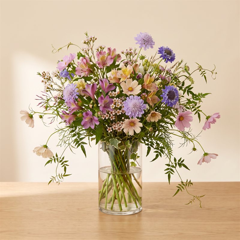 Grand garden-style arrangement with loose wild greenery