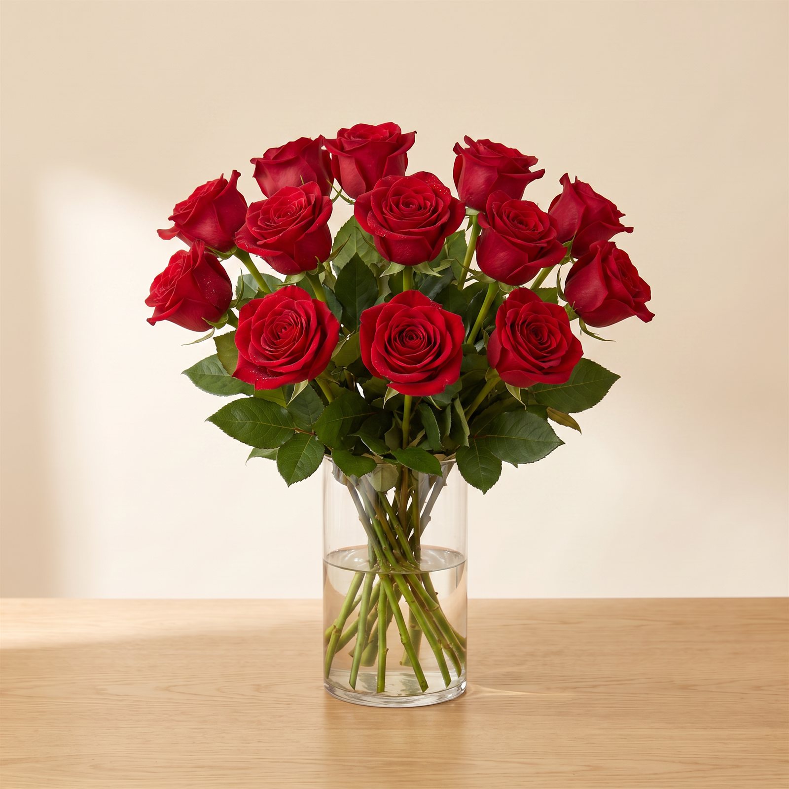 Deep-red garden roses hand-tied in a clear glass vase